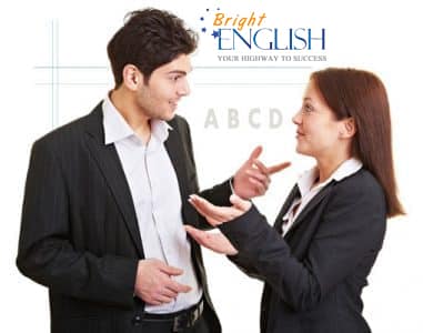 A businessman and businesswoman learn business English.