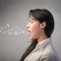 a profile of a woman with English letters of spoken English coming out of her mouth
