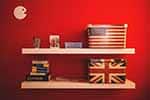 a shelf with the flag of Britain and the US signifying English practice