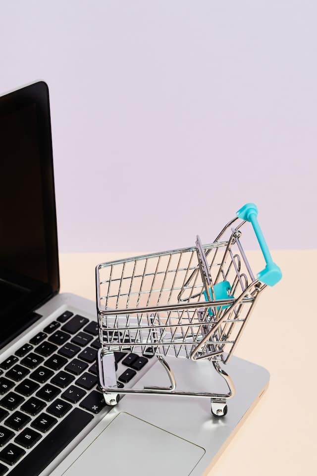 a laptop computer screen with a small shopping cart for easy enrollment for toefl preparation